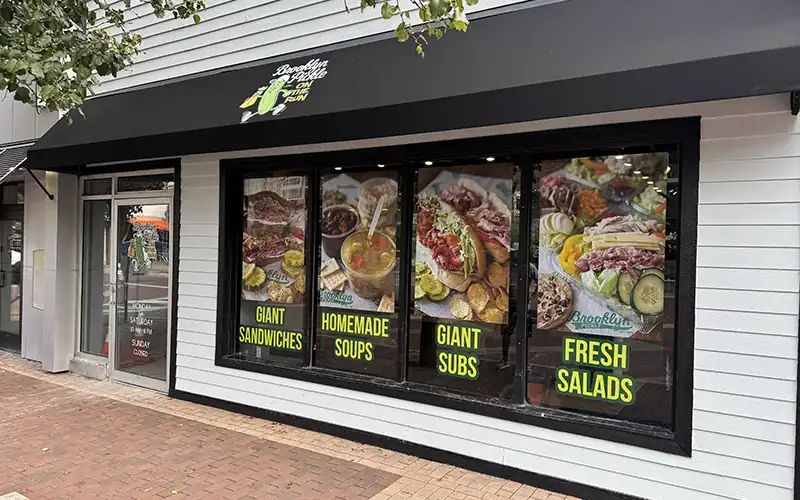 Brooklyn Pickle Marshall Street storefront with food posters in the windows